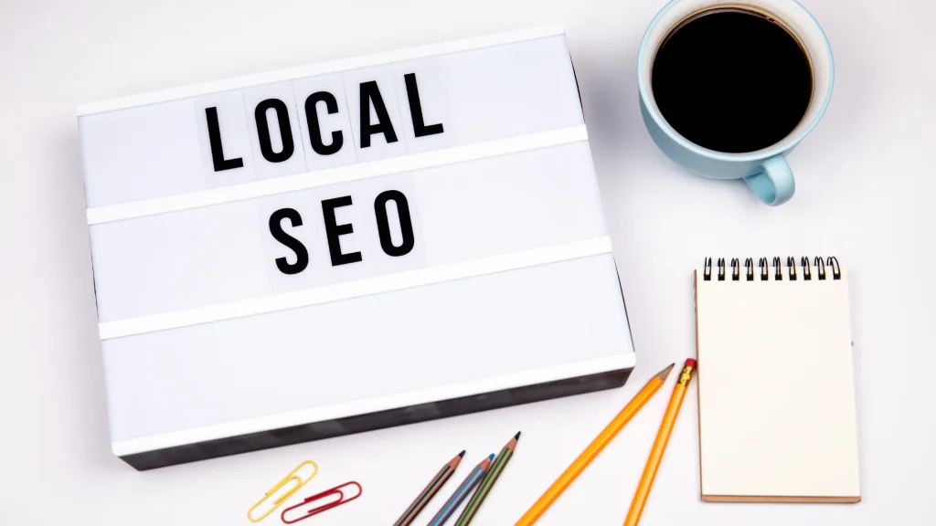 Lightbox displaying 'LOCAL SEO' text, with office supplies, emphasizing Local SEO Services for Businesses.