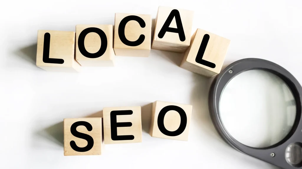 Wooden blocks spelling 'LOCAL SEO' with a magnifying glass, representing Local SEO Services for Businesses.